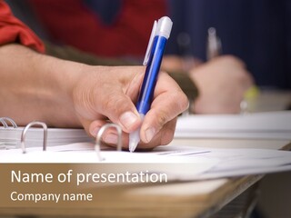 Detail Of A Hand Of Man With Red Shirt Writing On A Notebook With A Blue Pencil And Blurred Background PowerPoint Template