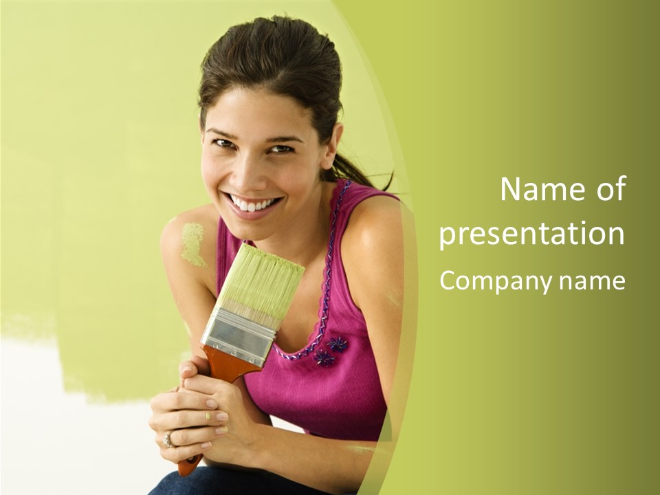 Pretty Smiling Woman Kneeling In Front Of Partially Painted Wall Holding Paintbrush. PowerPoint Template