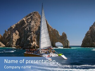 A Sailboat In The Ocean With Rocks In The Background PowerPoint Template