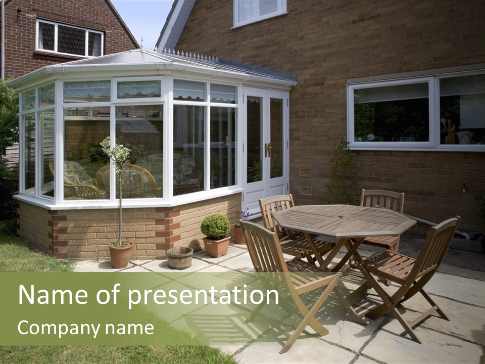 A Patio With A Table And Chairs In Front Of A House PowerPoint Template
