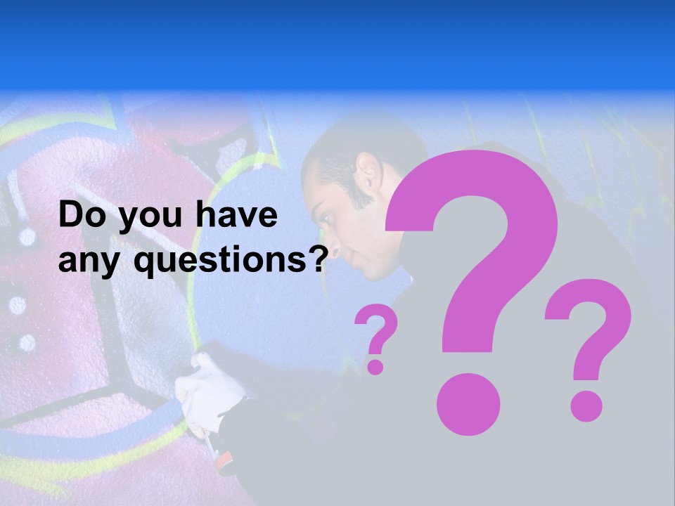 A Man In A Hoodie Writing On A Wall With Graffiti PowerPoint Template