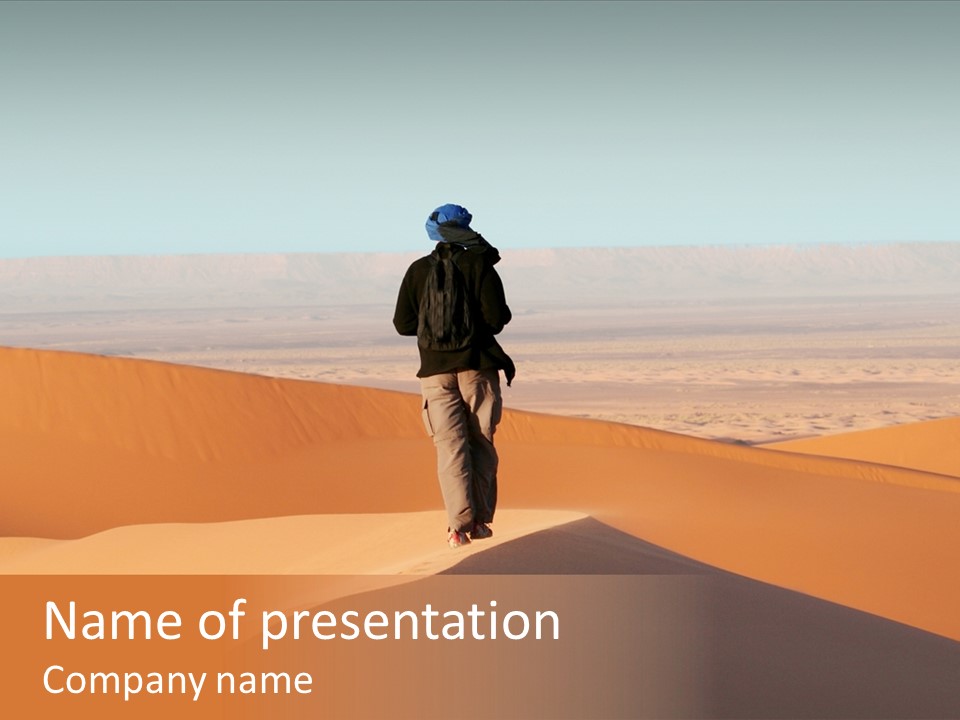 A Man Walking Across A Desert With A Sky Background PowerPoint Template