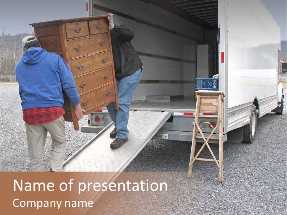 Two Men Carry Chest Of Drawers Onto A Moving Van PowerPoint Template