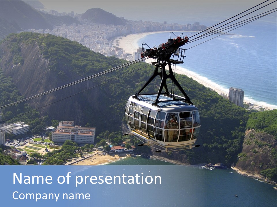 A Cable Car Going Up A Mountain With A City In The Background PowerPoint Template