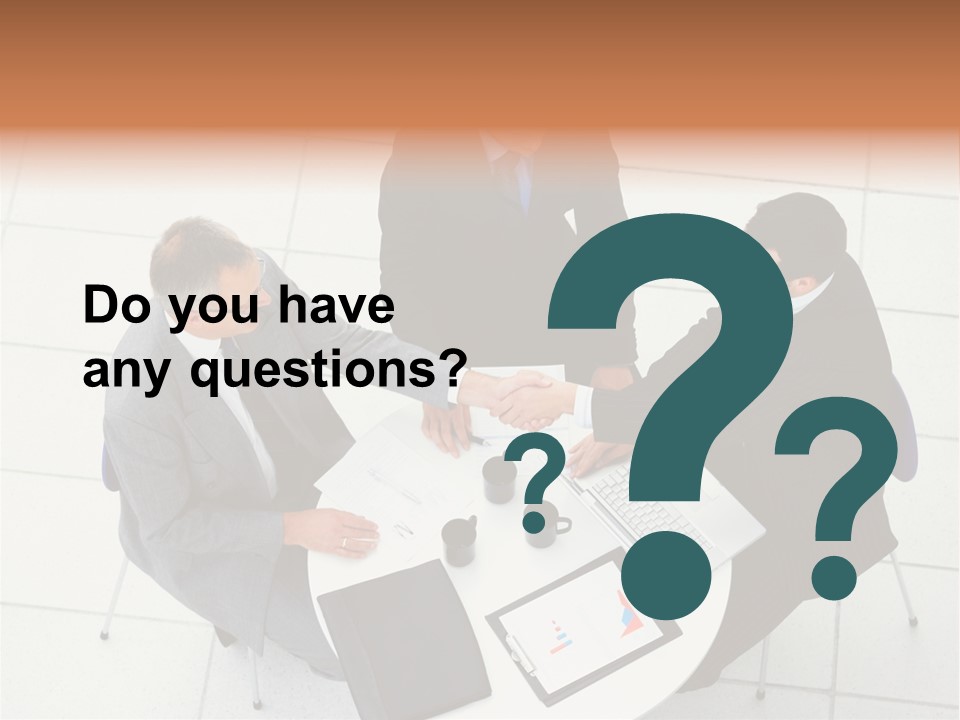 A Group Of Business People Shaking Hands Over A Table PowerPoint Template