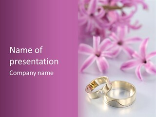 Two Gold Wedding Rings Sitting On Top Of A Table PowerPoint Template