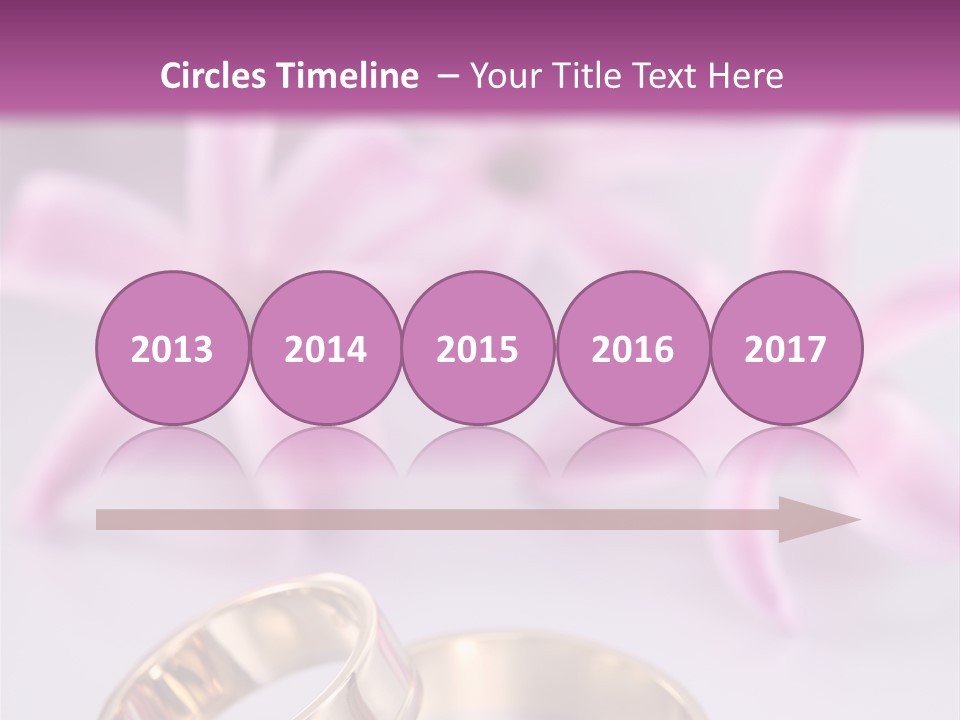 Two Gold Wedding Rings Sitting On Top Of A Table PowerPoint Template