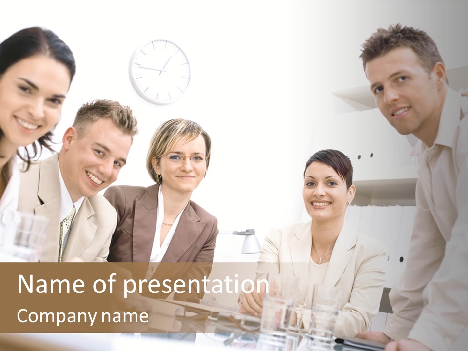 Five Business Colleagues Sitting Around Table And Working Together, Looking At Camera, Smiling. PowerPoint Template