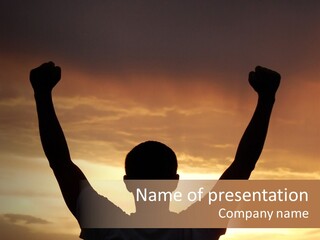 A Man Raising His Arms In The Air At Sunset PowerPoint Template