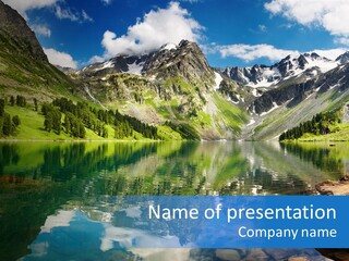 A Mountain Lake Surrounded By Green Trees And Rocks PowerPoint Template