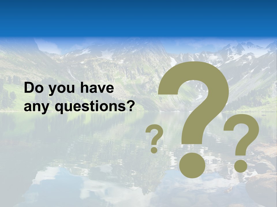 A Mountain Lake Surrounded By Green Trees And Rocks PowerPoint Template