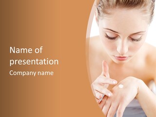 Young Beautiful Woman Applying Hands Cream And Looking At Camera PowerPoint Template