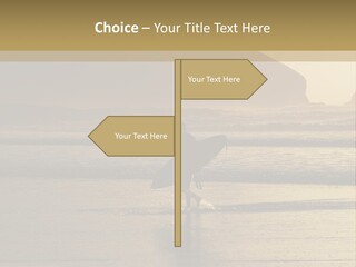 A Surfer Leaves The Surf As The Sun Sets At Polzeath Beach In Cornwall, Uk. PowerPoint Template