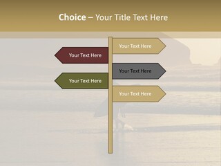 A Surfer Leaves The Surf As The Sun Sets At Polzeath Beach In Cornwall, Uk. PowerPoint Template