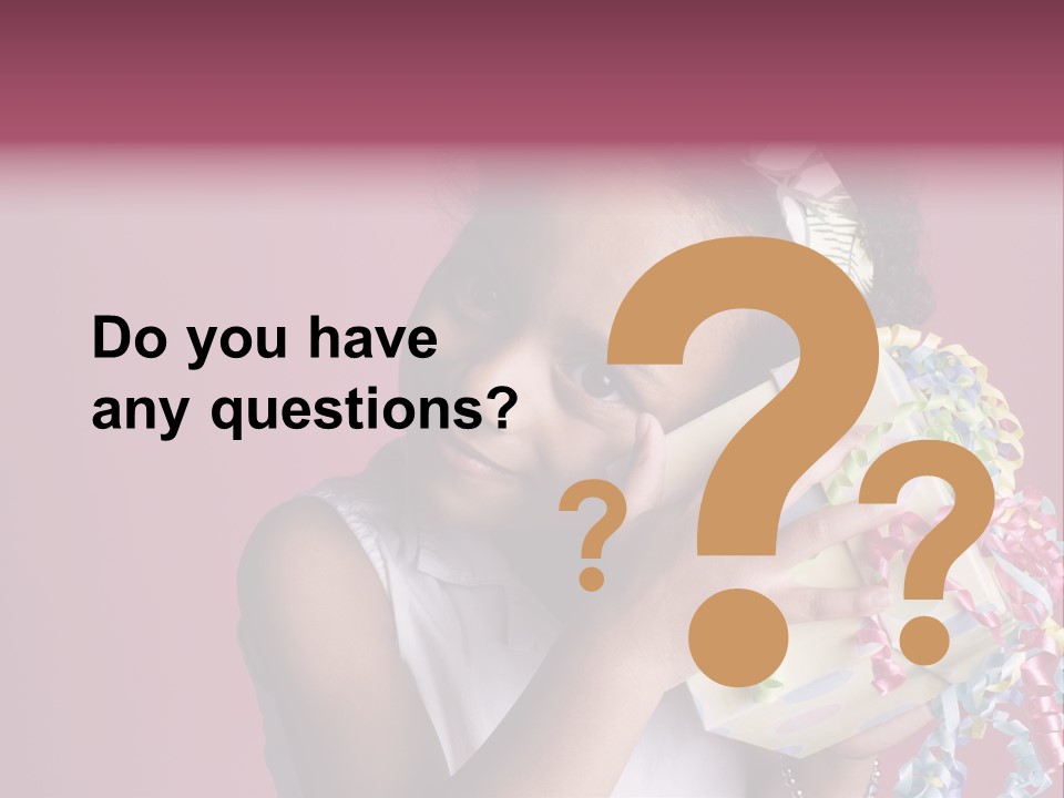 Portrait Of A Young Black Girl Sitting In A Chair Holding A Present PowerPoint Template