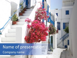 A White Building With A Blue Door And Stairs PowerPoint Template