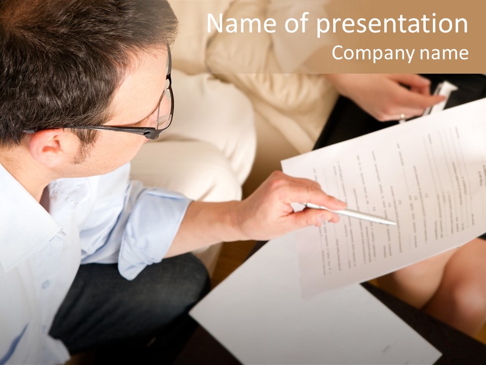 A Man Is Writing On A Piece Of Paper PowerPoint Template