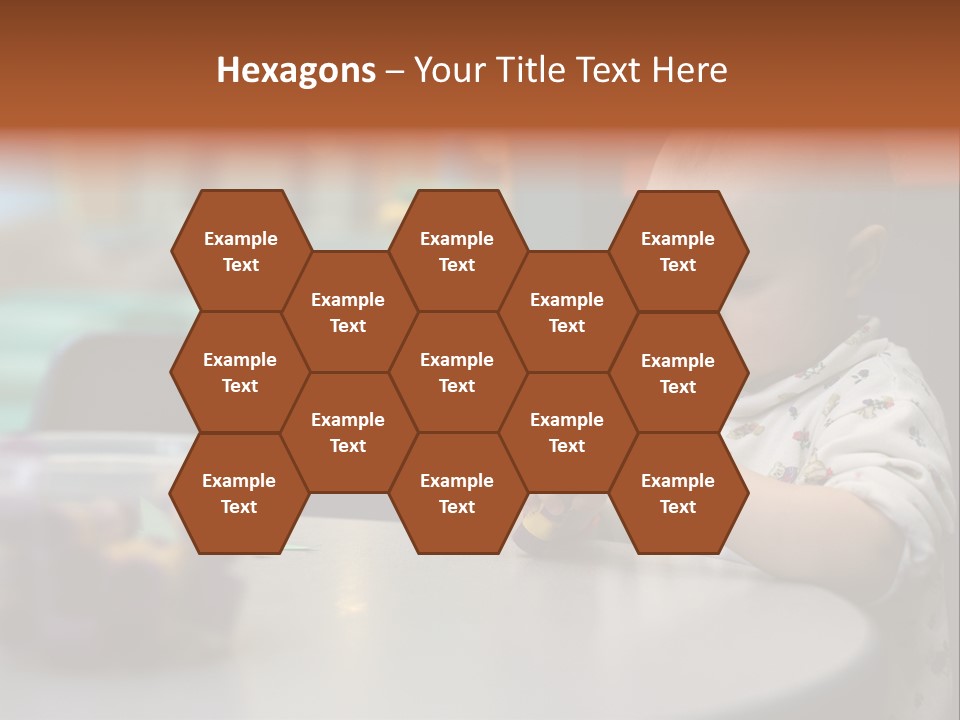 A Baby Sitting At A Table Playing With A Toy PowerPoint Template