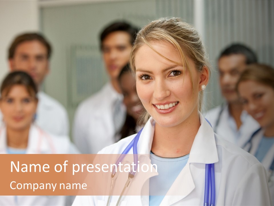 Female Doctor Smiling In A Hospital With Her Team Behind PowerPoint Template