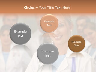 Female Doctor Smiling In A Hospital With Her Team Behind PowerPoint Template