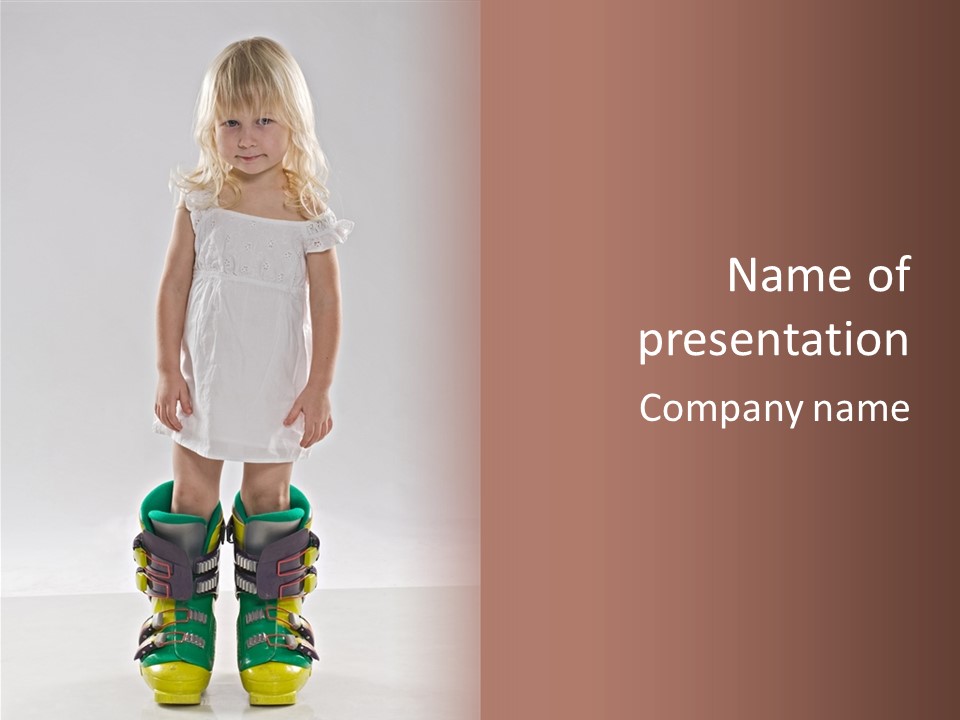 Funny Little Girl In Big Mountain Ski Boots And Short White Dress Stands On White Background PowerPoint Template