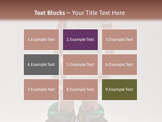 Funny Little Girl In Big Mountain Ski Boots And Short White Dress Stands On White Background PowerPoint Template