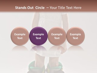 Funny Little Girl In Big Mountain Ski Boots And Short White Dress Stands On White Background PowerPoint Template