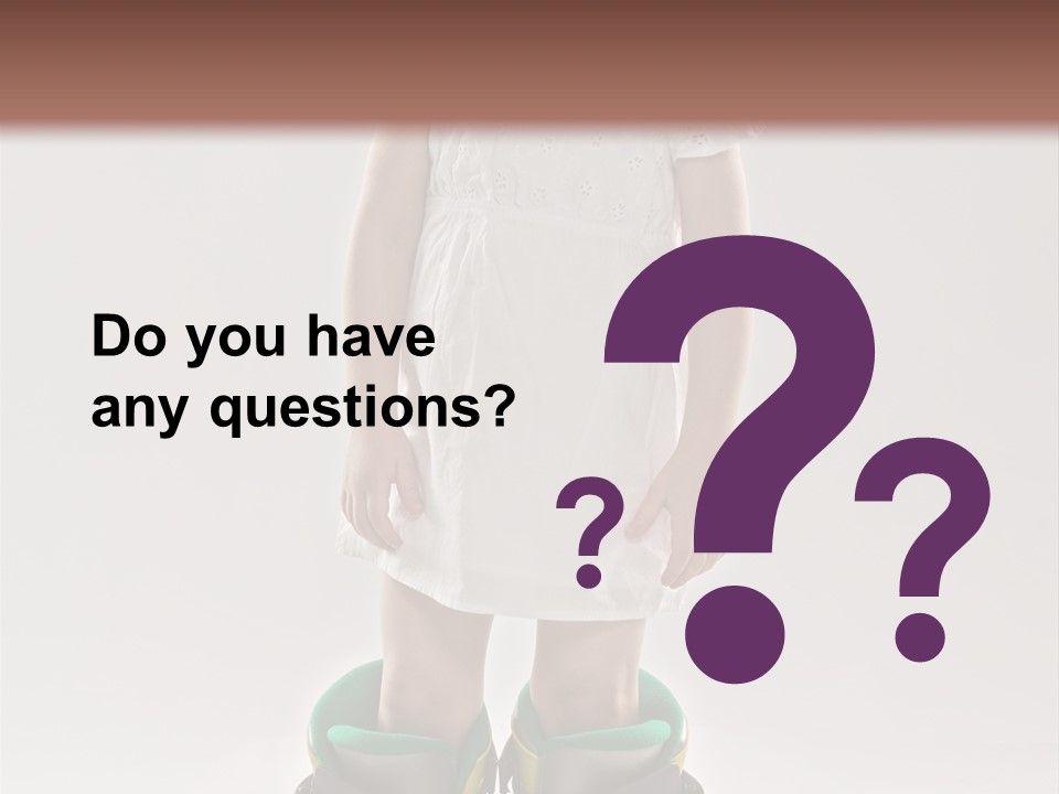 Funny Little Girl In Big Mountain Ski Boots And Short White Dress Stands On White Background PowerPoint Template