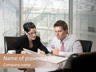 A Man And A Woman Sitting At A Table In Front Of A Laptop PowerPoint Template