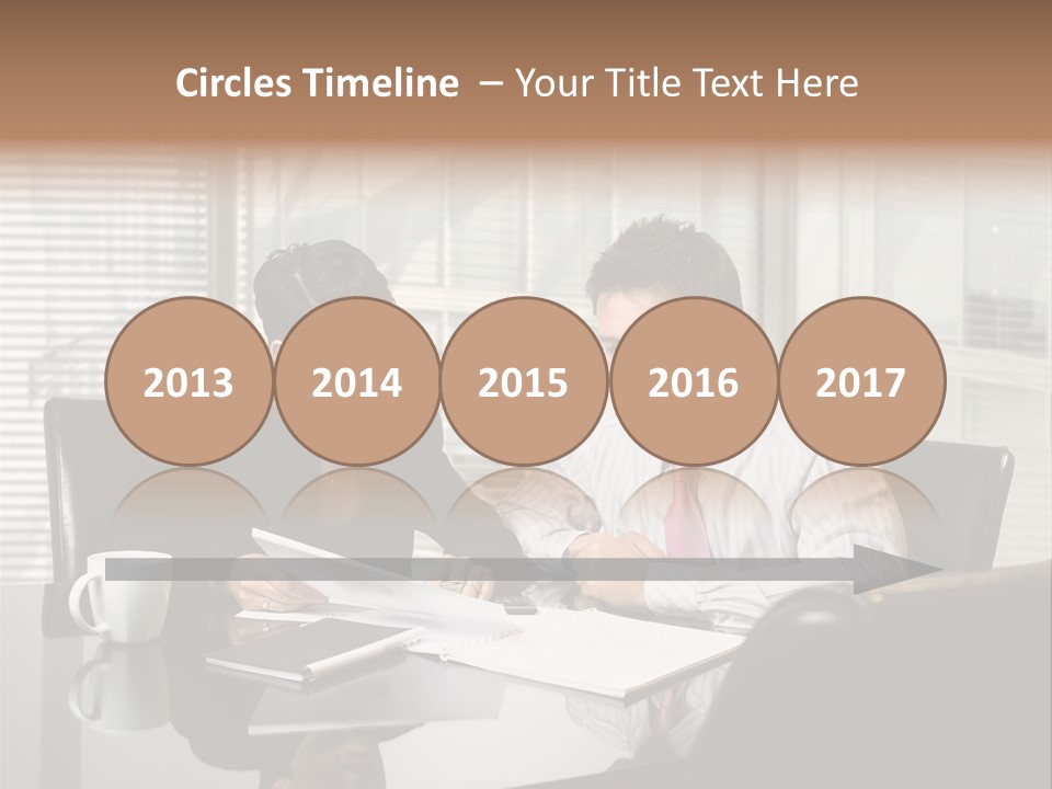 A Man And A Woman Sitting At A Table In Front Of A Laptop PowerPoint Template