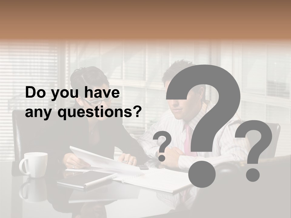 A Man And A Woman Sitting At A Table In Front Of A Laptop PowerPoint Template