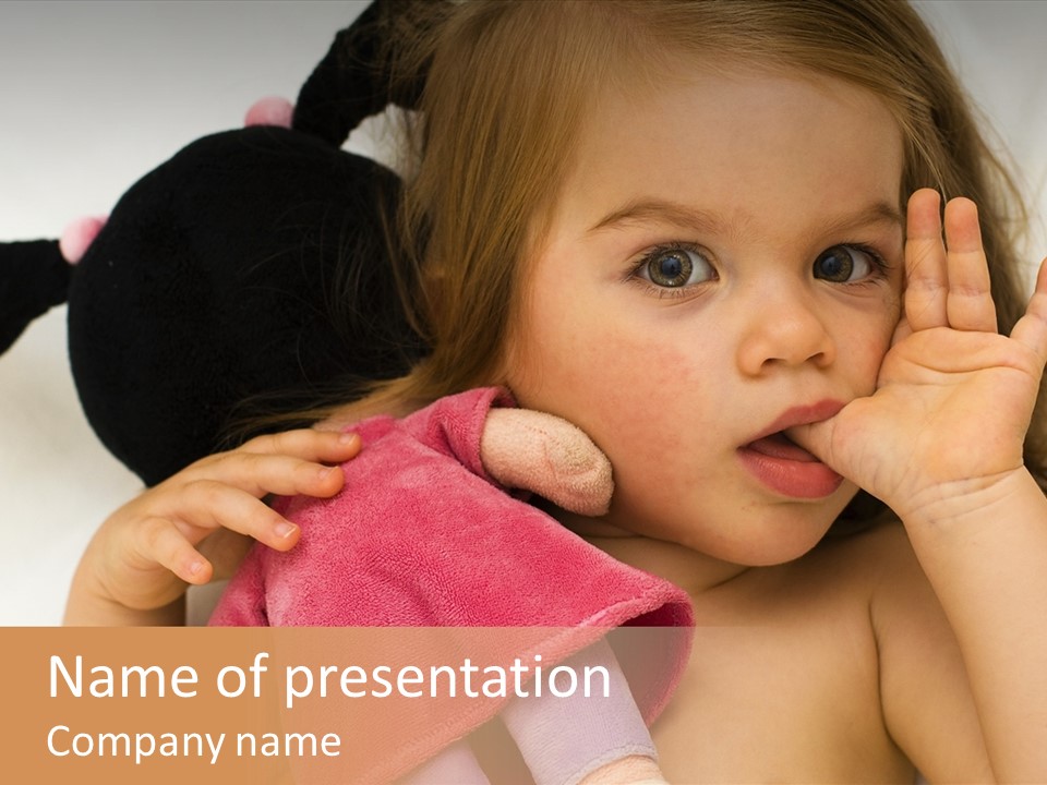 A Little Girl Laying On Top Of A Bed Holding A Stuffed Animal PowerPoint Template