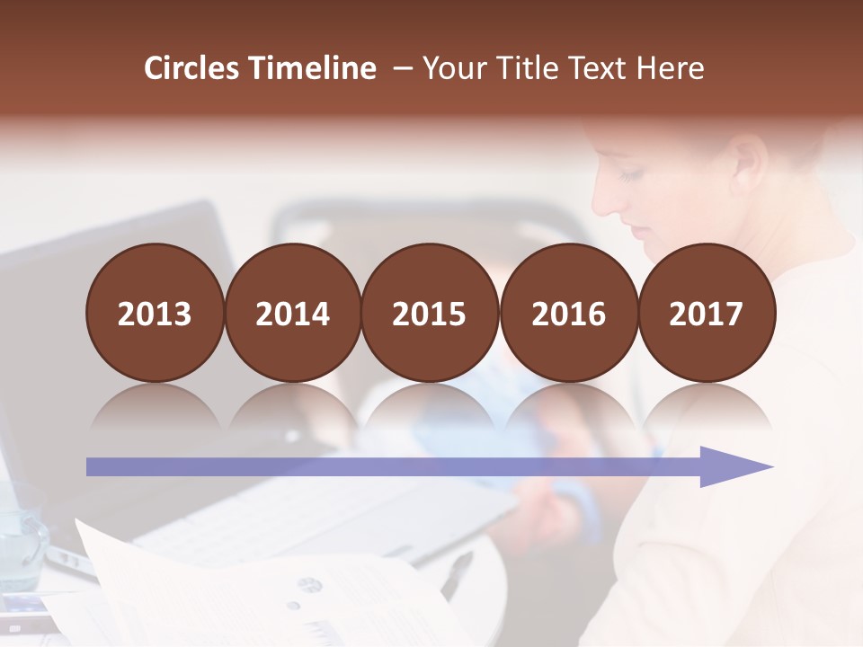 A Woman Holding A Baby In Her Lap While Looking At A Laptop PowerPoint Template