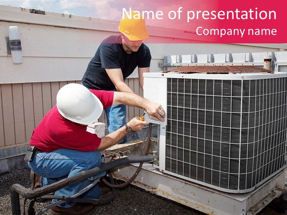 Two Workers On The Roof Of A Building Working On The Air Conditioning Unit. PowerPoint Template