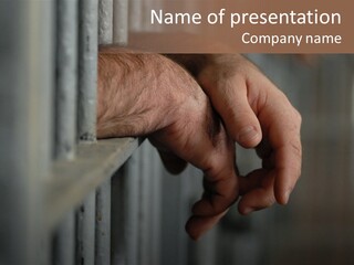 Mans Hands Behind Bars In Jail Or Prison PowerPoint Template