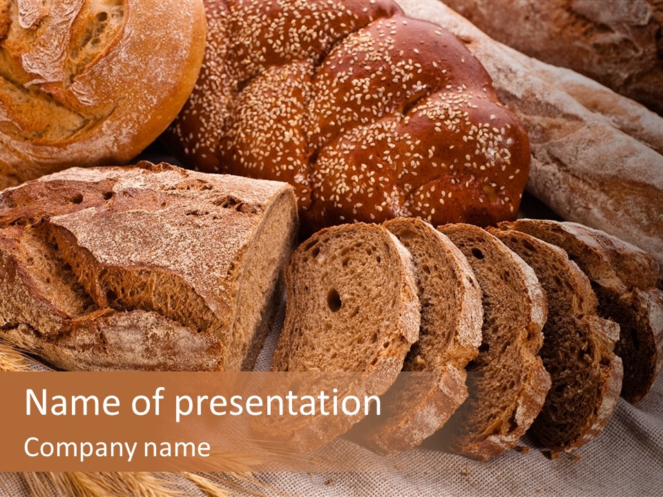 Sliced Country-Styled Brown Bread Baton And Rye Spikes On The Canvas Tablecloth With Bread Loafs Assortment PowerPoint Template