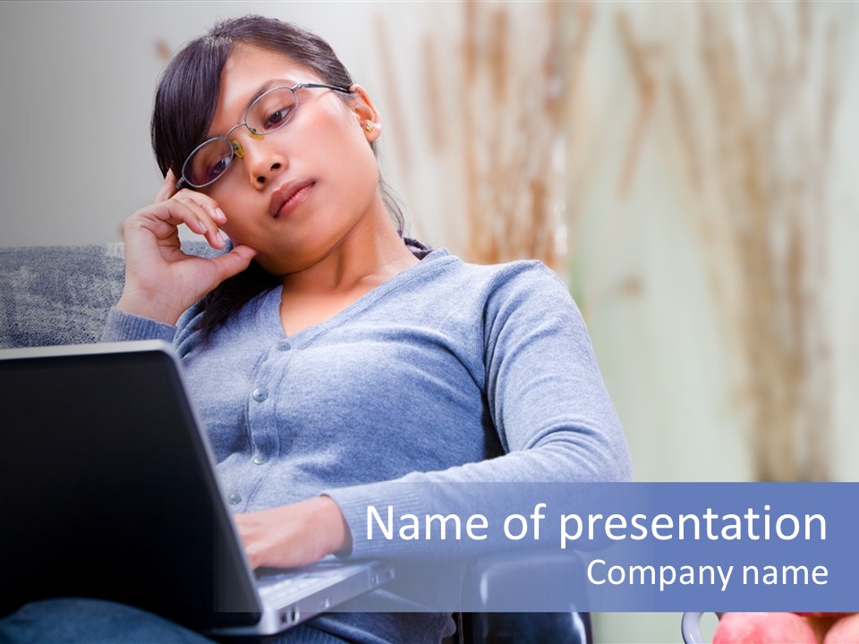 A Woman Talking On A Cell Phone While Using A Laptop PowerPoint Template