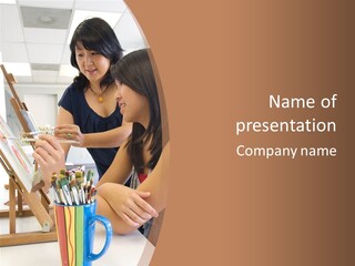 Two Women Sitting At A Table Looking At A Picture PowerPoint Template