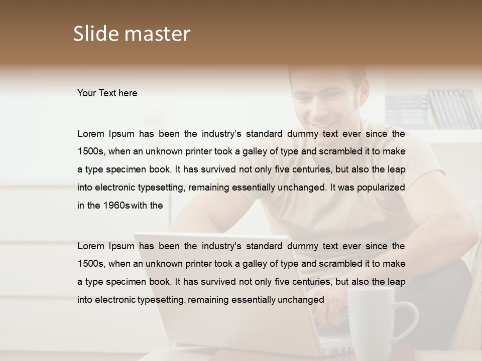 Happy Young Man In T-Shirt Sitting On Sofa At Home, Working On Laptop Computer, Smiling. PowerPoint Template