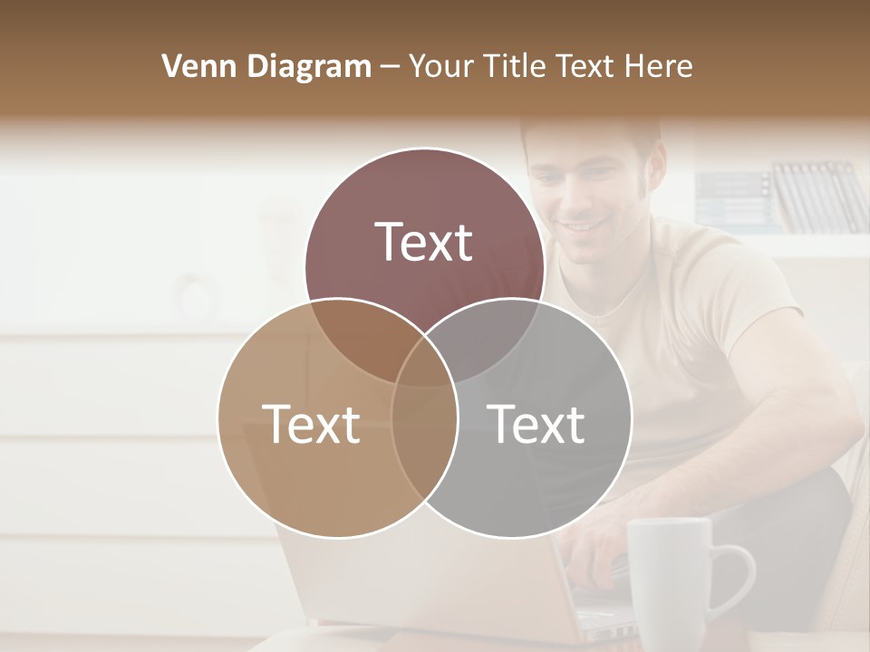 Happy Young Man In T-Shirt Sitting On Sofa At Home, Working On Laptop Computer, Smiling. PowerPoint Template