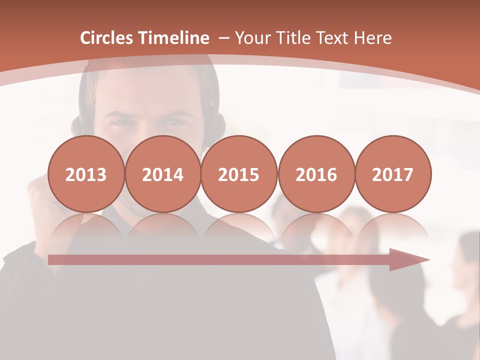 A Man Wearing A Headset With A Group Of People In The Background PowerPoint Template