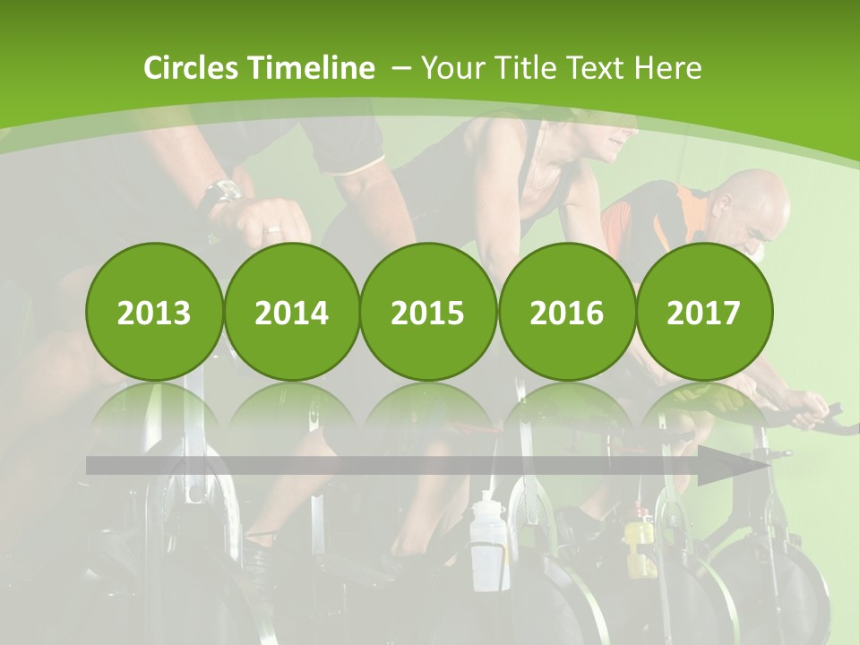 A Group Of People Riding Stationary Bikes In A Gym PowerPoint Template