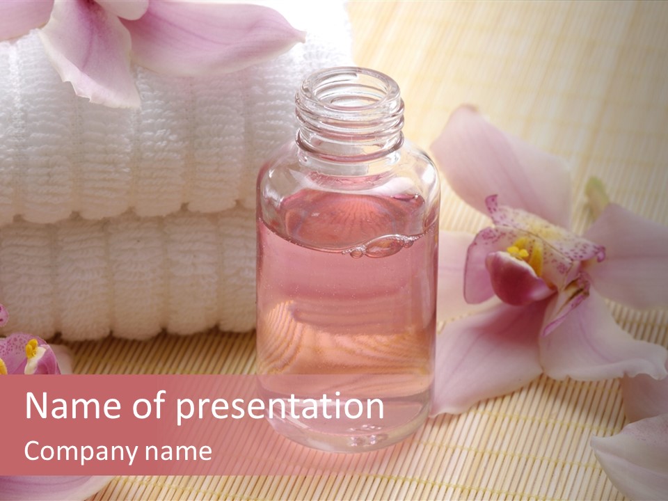 A Bottle Of Perfume Next To A Towel And Flowers PowerPoint Template