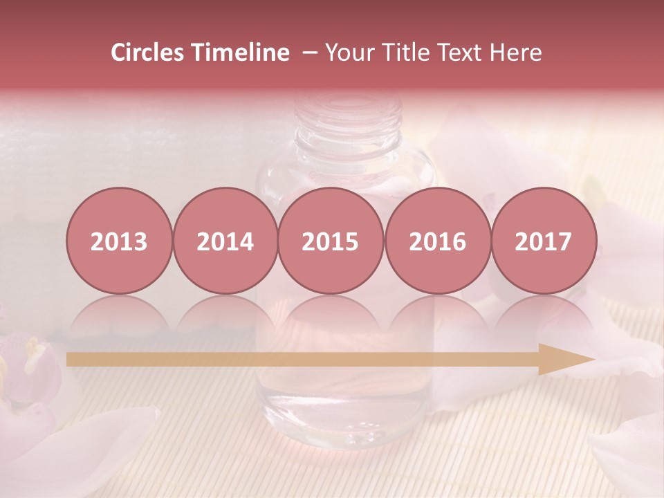 A Bottle Of Perfume Next To A Towel And Flowers PowerPoint Template