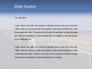 A Boardwalk With Benches And Flowers On The Beach PowerPoint Template