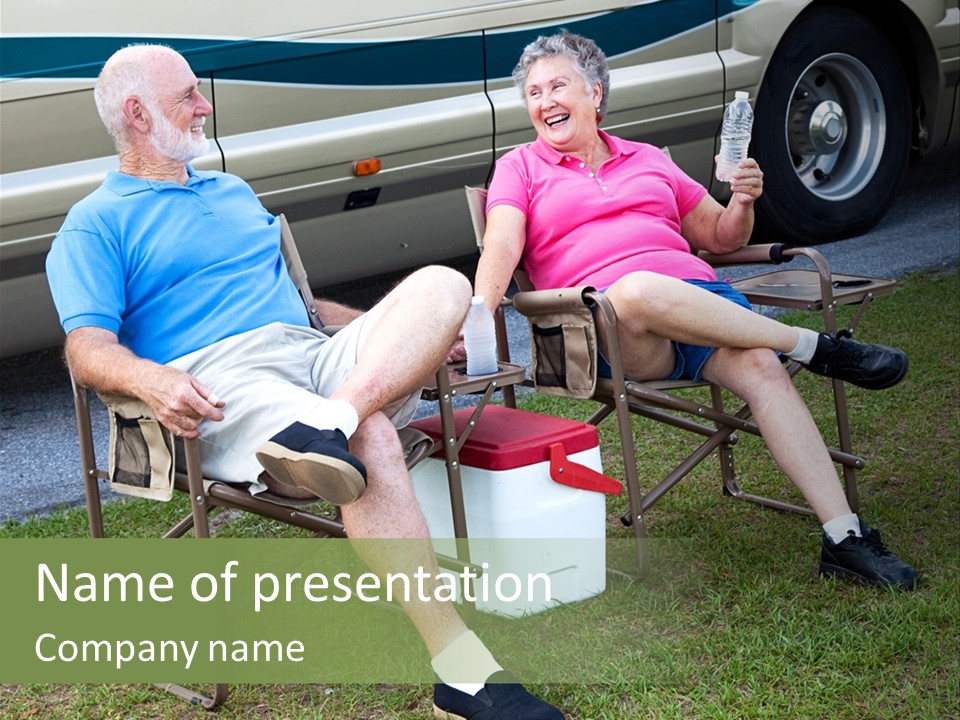 Senior Campers Sitting In Folding Chairs Outside Their Motor Home. PowerPoint Template