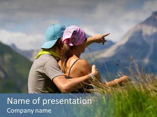 A Couple Of People Sitting On Top Of A Grass Covered Field PowerPoint Template