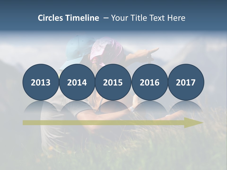 A Couple Of People Sitting On Top Of A Grass Covered Field PowerPoint Template