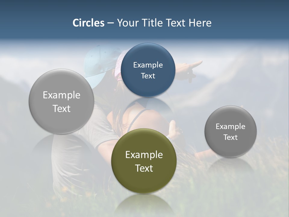 A Couple Of People Sitting On Top Of A Grass Covered Field PowerPoint Template