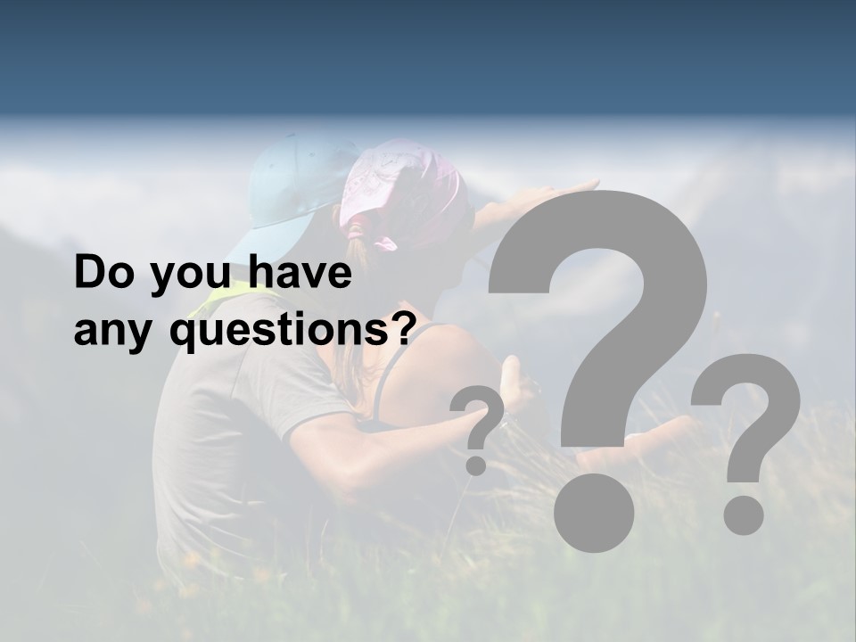 A Couple Of People Sitting On Top Of A Grass Covered Field PowerPoint Template